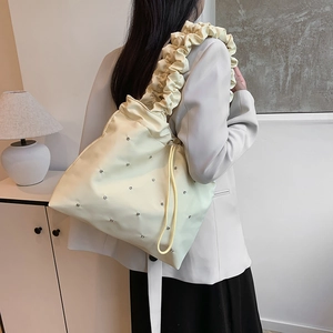 Beige waterproof nylon tote bag with drawstring, rhinestones and ruched shoulder strap