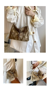 Detail of bronze gold velvet pleated shoulder bag with drawstring and elegant texture