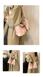 Detail of pink pleated velvet tote bag with drawstring closure and metal bead accents