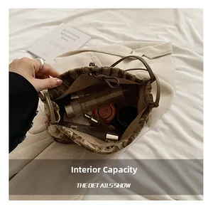 Large capacity detail of velvet bucket bag showing interior space for cosmetics