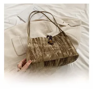 Detail of brown tie-dye tote bag with bamboo patterns and amber drawstring closure