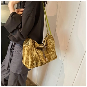 Artistic ginger velvet shoulder bag featuring green bamboo patterns and drawstring closure