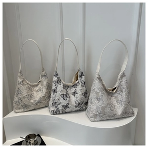Three elegant butterfly lace embroidery tote bags on a minimalist white display