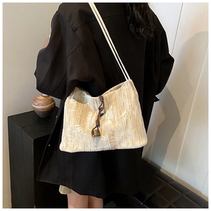 Detail of bamboo leaf jacquard fabric on the off-white shoulder bag with woven knot