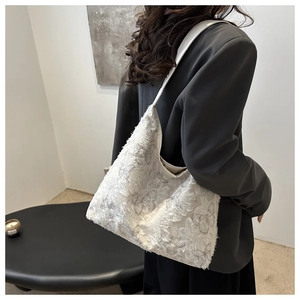 Detail view of white canvas tote bag with 3D fringe texture and gray butterfly patterns