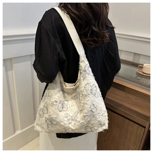 Detailed back view of spacious off-white canvas tote bag with blue butterfly patterns