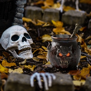 Halloween-Kessel Gartendekoration mit leuchtendem Totenkopfgesicht und Knochenstab