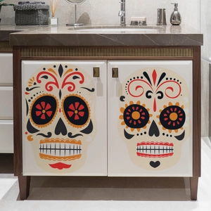 Detail of Day of the Dead skull wall stickers on a modern white bathroom cabinet door