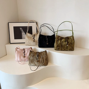 New Chinese style pleated velvet tote bags in five colors on a minimalist display