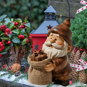 Detailed view of a Christmas gnome garden stake with textured resin finish and gift box