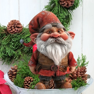Charming Christmas gnome garden stake with red hat and long beard in festive pine decor