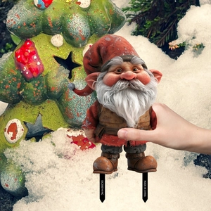 Close-up of PVC Christmas gnome garden stake with detailed red hat and grey beard texture