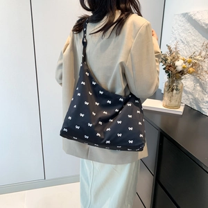 Large black canvas hobo bag with white bow pattern for women's daily commute