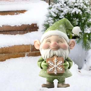 Detailed view of a green Christmas gnome with snowflake pattern holding a brown gift box