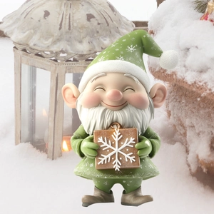 Festive Christmas garden gnome statue holding a gift box in a snowy outdoor winter setting