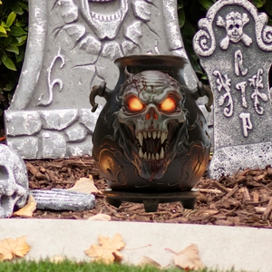 Glowing skull cauldron Halloween garden stake decoration with orange LED light eyes