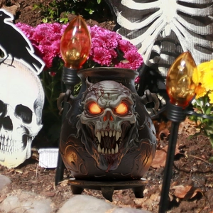 Halloween skull cauldron garden stake with glowing eyes and matte black finish