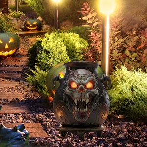 Halloween skull jar decoration with glowing red eyes on an outdoor garden pathway