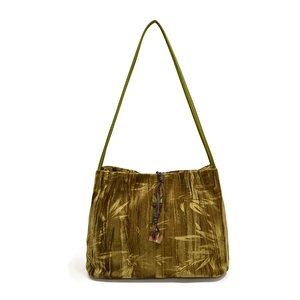Olive green velvet tote bag with bamboo patterns and decorative pendant strap