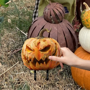 Detail of Halloween pumpkin garden stake showing realistic carved texture and ground spikes
