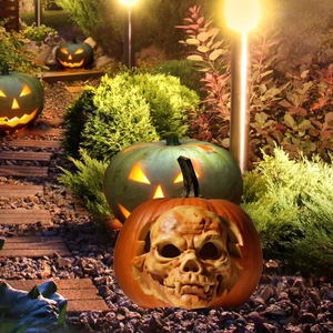 Outdoor Halloween pumpkin stake with skull face design for garden and yard pathway decor