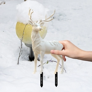 Detailed view of white reindeer garden stake with realistic fur texture on snow