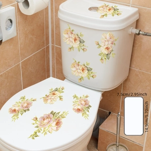Floral wall decal with hand-painted pink roses and gold foil edges on a white toilet lid