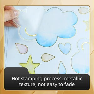 Detail of gold foil cloud and heart stickers with elegant metallic hot stamping texture