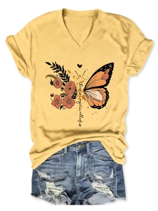 Detail of V-neck yellow t-shirt with floral butterfly print and magic quote text