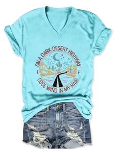 Detail of V-neck T-shirt with On A Dark Desert Highway print and ripped denim shorts