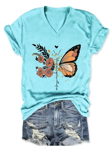 Detail of V-neck sky blue T-shirt with magic butterfly print and distressed denim shorts
