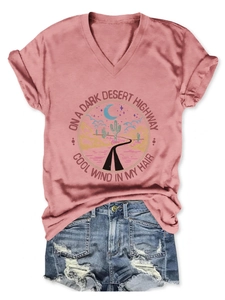 Detail of pink V-neck T-shirt with rolled sleeves and retro desert highway graphic print
