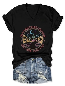 Detail of V-neck T-shirt with vintage desert highway print and distressed denim shorts