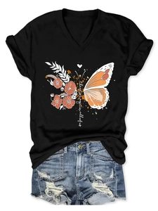 Detail of V-neck black T-shirt with floral butterfly and magic quote print