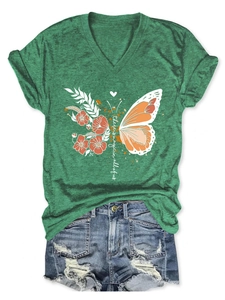 Detail of green V-neck T-shirt with butterfly print and magic typography