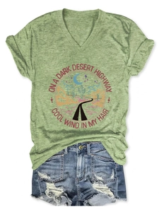 Detail of V-neck T-shirt with desert cactus print and distressed denim shorts