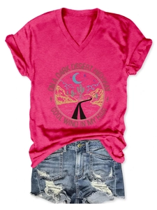 Flat lay of pink V-neck T-shirt with desert highway graphic and ripped denim shorts