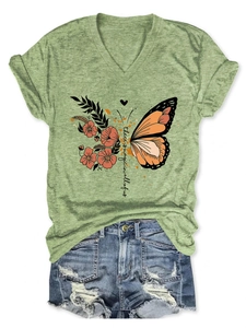 Detail view of flower butterfly print and there is magic text on V-neck t-shirt