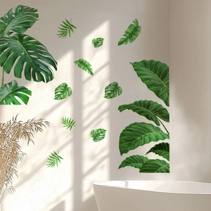 Tropical green palm leaf wall decals on a minimalist white wall with natural sunlight