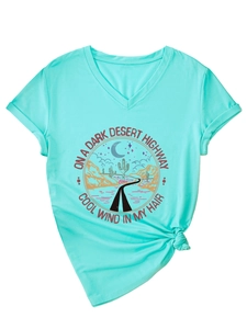 Detail of mint green V-neck T-shirt featuring desert graphic print and knotted hem