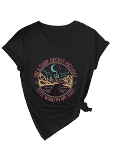 Detail of V-neck black T-shirt featuring vintage desert highway graphic and front hem knot