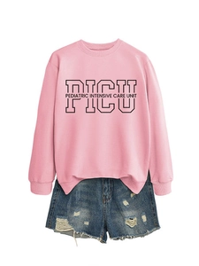 Flat lay of pink PICU sweatshirt with pediatric lettering and ripped denim shorts
