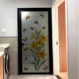 Detail of yellow lily flower and butterfly wall stickers applied on glass door panels