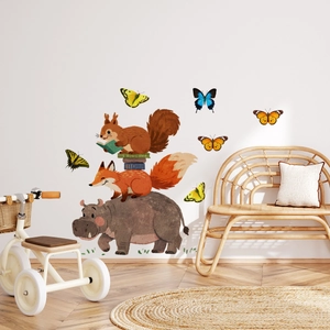 Detail of hand-painted animal wall stickers with hippo, fox, and butterflies in a kid's room
