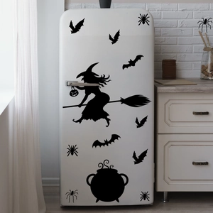 Close-up of Halloween wall stickers featuring a witch silhouette and bats on a white fridge