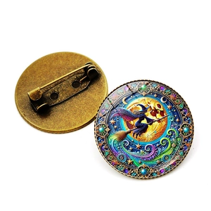 Detail of vintage bronze witch brooch showing fantasy artwork and secure pin clasp