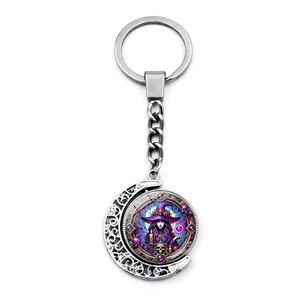 Detailed view of rotating crescent moon keychain with purple fantasy witch illustration