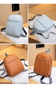 Detail of wave quilted texture and letter strap on faux leather mini backpacks