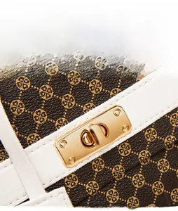 Macro detail of monogram crossbody bag with gold rotating lock and precise stitching