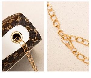 Close-up of golden chain strap and monogram leather stitching on women crossbody bag